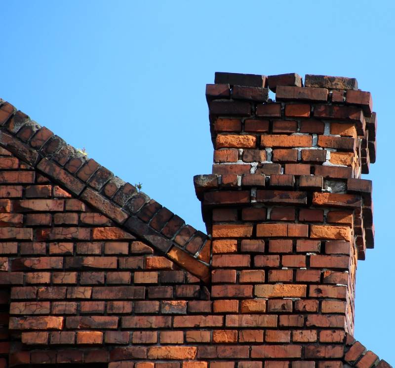 Signs Your Hamtramck Home Needs a Chimney Inspection Damaged chimney on an Hamtramck home showing cracks and missing mortar
